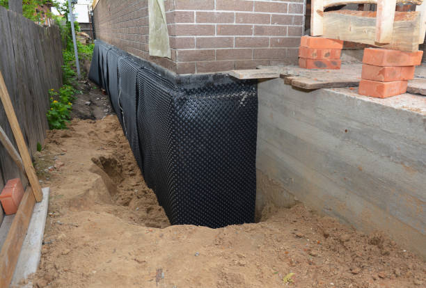 SJ Waterproofing Pros technician performing targeted Waterproofing assessment in Holton, MI